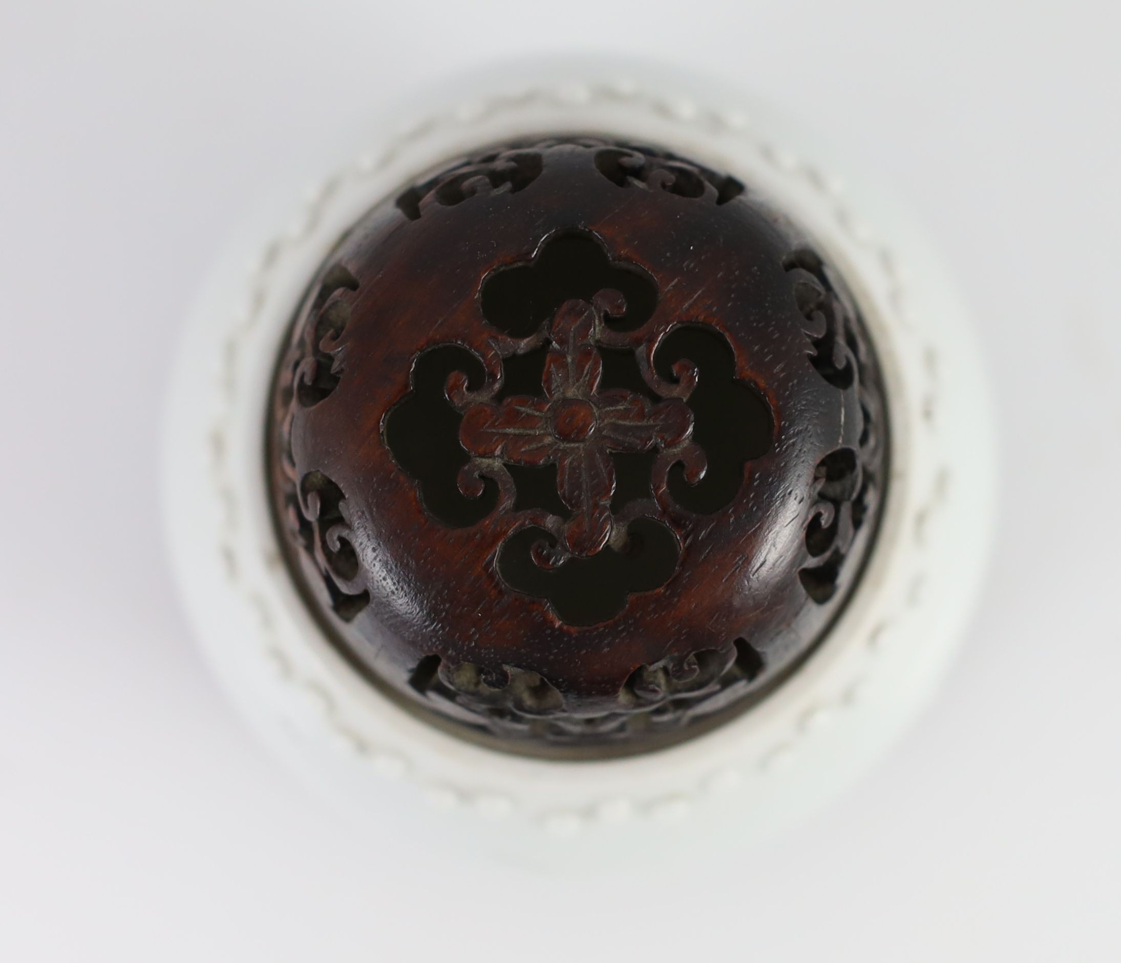 A Chinese blanc-de-chine jar, Dehua kilns, Kangxi period, 8cm high excluding wood cover and stand